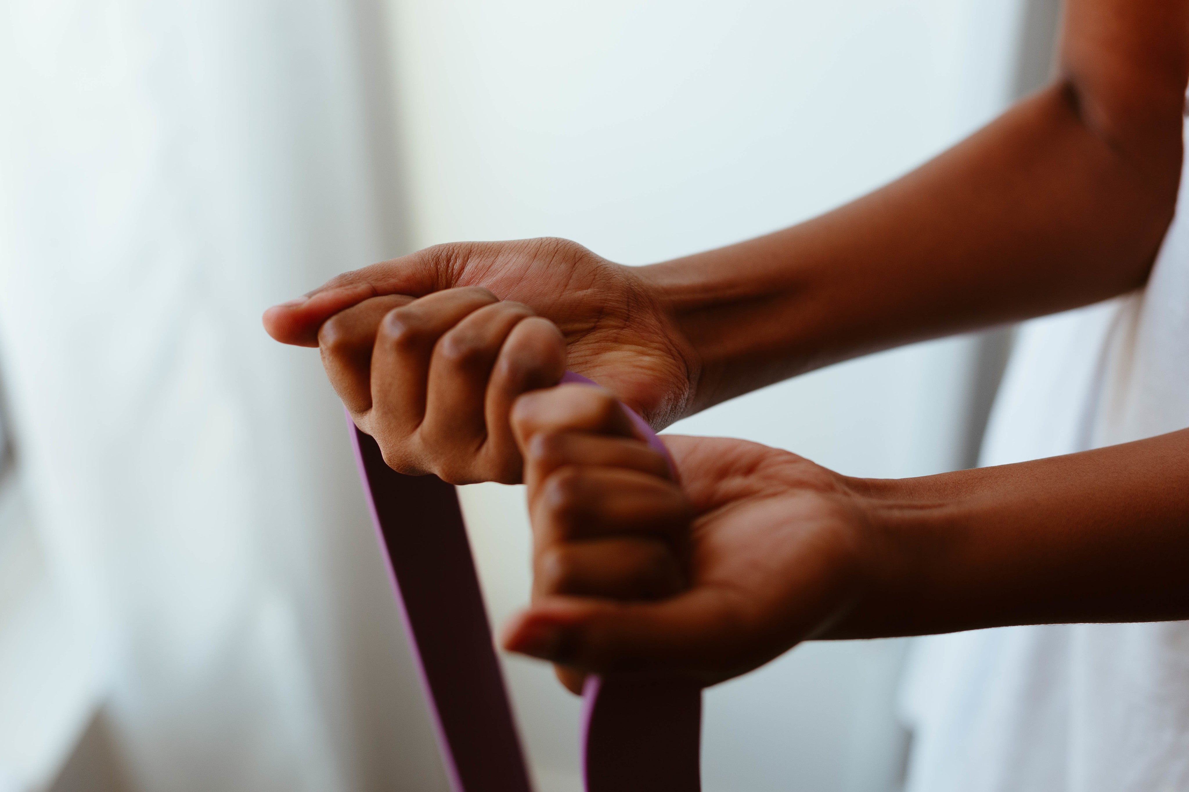 hands-grip-a-purple-rope.jpg